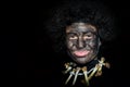 Happy little boy with face painted with charcoal and afro wig cos Royalty Free Stock Photo