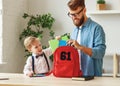 Father and kid preparing school backpack Royalty Free Stock Photo