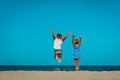 Happy little boy and girl enjoy play jump on beach Royalty Free Stock Photo