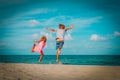 Happy little boy and girl enjoy play jump on beach Royalty Free Stock Photo