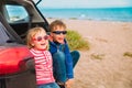 Happy little boy and girl enjoy travel by car at beach Royalty Free Stock Photo