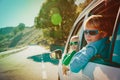 Happy little boy and girl enjoy travel by car in mountains Royalty Free Stock Photo