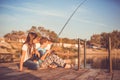 Happy little boy and girl fishing on a lake in a sunny summer day Royalty Free Stock Photo