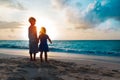 Happy little boy and girl holding hands at sunset Royalty Free Stock Photo