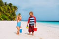 Happy little boy and girl play with sand on beach Royalty Free Stock Photo