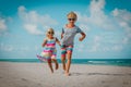 Happy little boy and girl run play at beach Royalty Free Stock Photo
