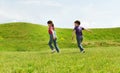 Happy little boy and girl running outdoors Royalty Free Stock Photo