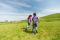 Happy little boy and girl running outdoors Royalty Free Stock Photo