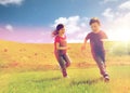 Happy little boy and girl running outdoors Royalty Free Stock Photo