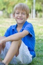 Happy little boy in the green park