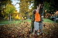 Happy little boy have fun playing with fallen golden leaves Royalty Free Stock Photo