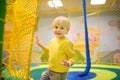 Happy little boy having fun in amusement in play center. Child playing on indoor playground Royalty Free Stock Photo