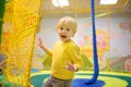 Happy little boy having fun in amusement in play center. Child playing on indoor playground Royalty Free Stock Photo