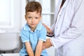 Happy little boy having fun while is being examine by doctor with stethoscope Royalty Free Stock Photo