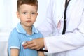 Happy little boy having fun while is being examine by doctor with stethoscope Royalty Free Stock Photo
