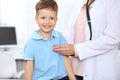 Happy little boy having fun while is being examine by doctor with stethoscope Royalty Free Stock Photo