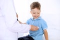 Happy little boy having fun while is being examine by doctor by stethoscope. Health care, insurance and help concept Royalty Free Stock Photo
