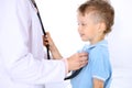 Happy little boy having fun while is being examine by doctor by stethoscope. Health care, insurance and help concept Royalty Free Stock Photo