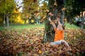 Happy little boy have fun playing with fallen golden leaves Royalty Free Stock Photo