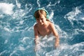 Happy little boy having fun in summer swimming pool. Family vacation. Royalty Free Stock Photo