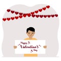 Happy little boy holding a poster with text Happy Valentine's Day and red hearts. Love concept. Happy Valentine Royalty Free Stock Photo