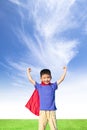 Happy little boy imitate superhero and open arms with blue sky