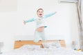 Happy little boy jumping on bed Royalty Free Stock Photo