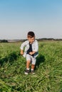 Happy little boy jumping on grass in summer day Royalty Free Stock Photo