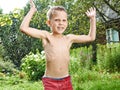 Happy little boy is jumping under rain Royalty Free Stock Photo