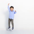 Happy little boy jumping on white background Royalty Free Stock Photo