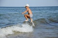 A happy little boy jumps over a sea wave Royalty Free Stock Photo