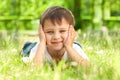Happy little boy laying on the grass Royalty Free Stock Photo