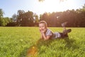 Happy little boy laying on the grass