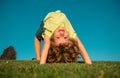 Happy little boy laying upside down on grass. Kids exploring nature, summertime. Royalty Free Stock Photo
