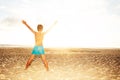 Boy look at see sunset beach with stretched hands Royalty Free Stock Photo