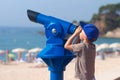 Happy little boy looking in telescope at Lloret beach Royalty Free Stock Photo