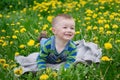 Happy little boy lying on a blanket on a meadow in spring Royalty Free Stock Photo