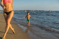 Happy little boy with mother running on summer beach. Positive human emotions, feelings, joy. Funny cute child making vacations an Royalty Free Stock Photo