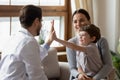 Happy boy patient give high five to caring doctor Royalty Free Stock Photo