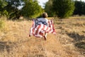 Happy little boy patriot running in the field with American flag Royalty Free Stock Photo