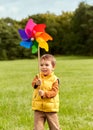 happy little boy with pinwheel playing at park Royalty Free Stock Photo