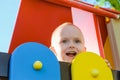 Happy little boy on playground. Laughing boy outdoors play. Royalty Free Stock Photo