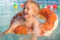 Happy little boy playing with colorful inflatable ring