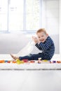 Happy little boy playing on floor Royalty Free Stock Photo