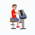 Happy little boy playing piano with red shirt