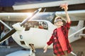 Happy little boy playing with small toy airplane near hangar Royalty Free Stock Photo