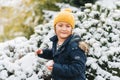 Happy little boy playing with snow outside Royalty Free Stock Photo