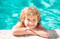 Happy little boy playing in swimming pool outdoor on hot summer day. Children fun. Enjoying in swimming pool. Royalty Free Stock Photo