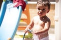 Happy little boy playing with water hose in the backyard Royalty Free Stock Photo