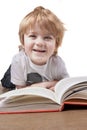 Happy little boy reading and smiling Royalty Free Stock Photo